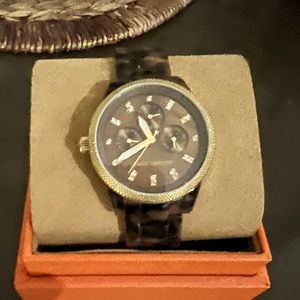 Michael Kors tortise shell in color.